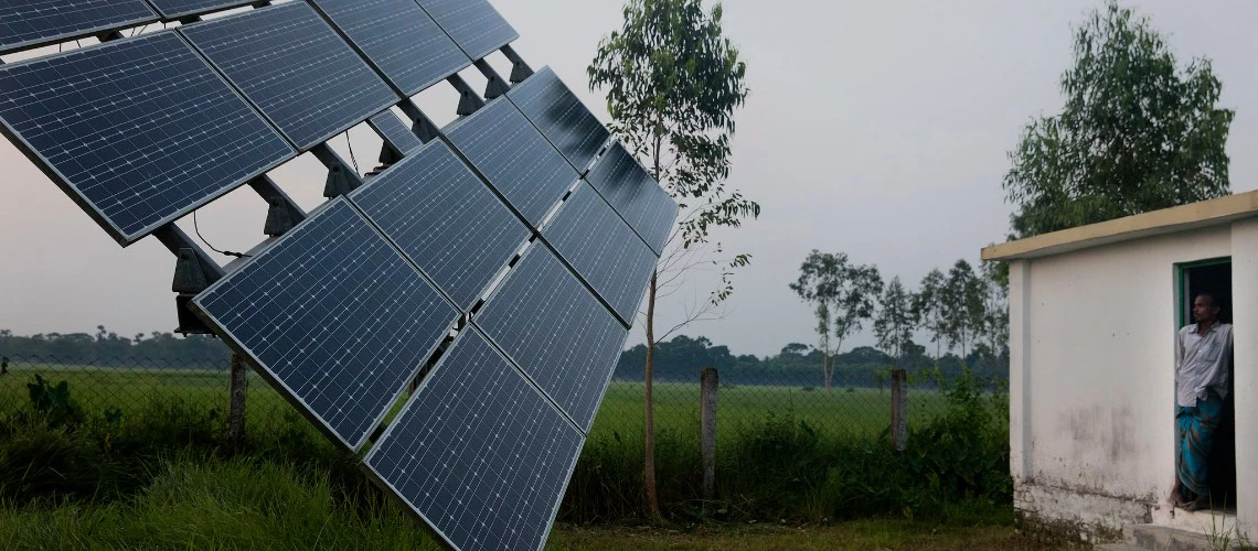 Manik, a solar pump operator for Nusra works near the solar panels in Rohertek, Bangladesh on October 12, 2016