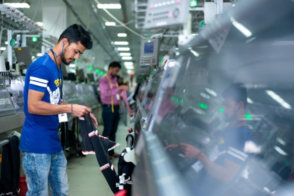 photo of man working at machine