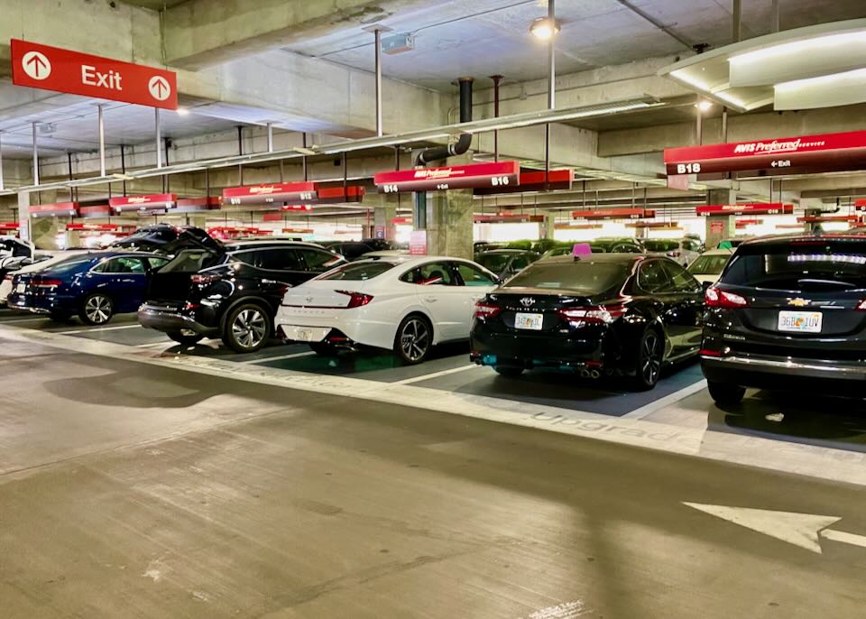 SUVs and sedans parked and awaiting pickup. 