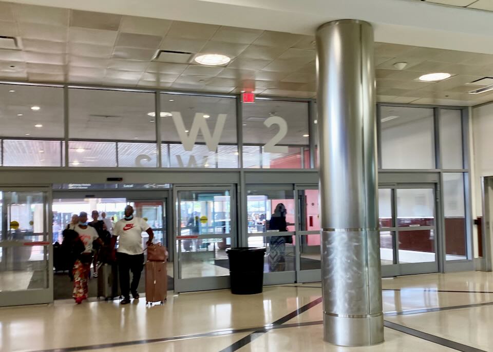 Inside the airport a set of doors have W2 painted on them .