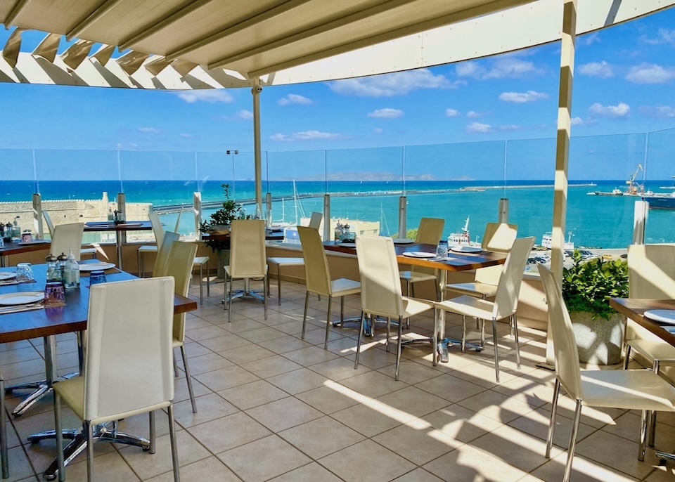 Rooftop restaurant overlooking the harbor and Venetian fortress at Lato Boutique Hotel in Crete