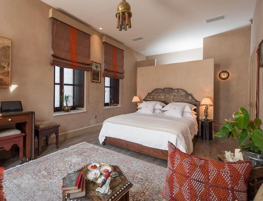 Elaborate Moroccan and Mid-Eastern textiles, inlayed wood, and light fixtures decorate a guest room at La Maison Ottomane in Crete