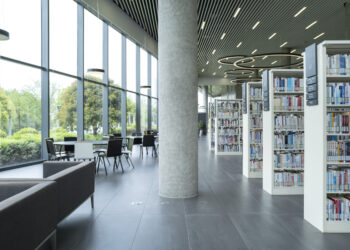 Interior photo of a library featuring stacks of books and sofas