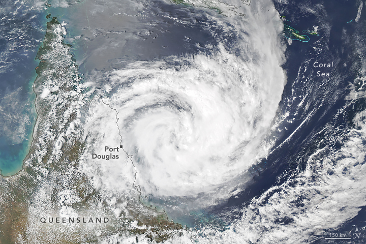 aerial of swirling white clouds centered over the coral sea off the coast of Port Douglass, Queensland Australia