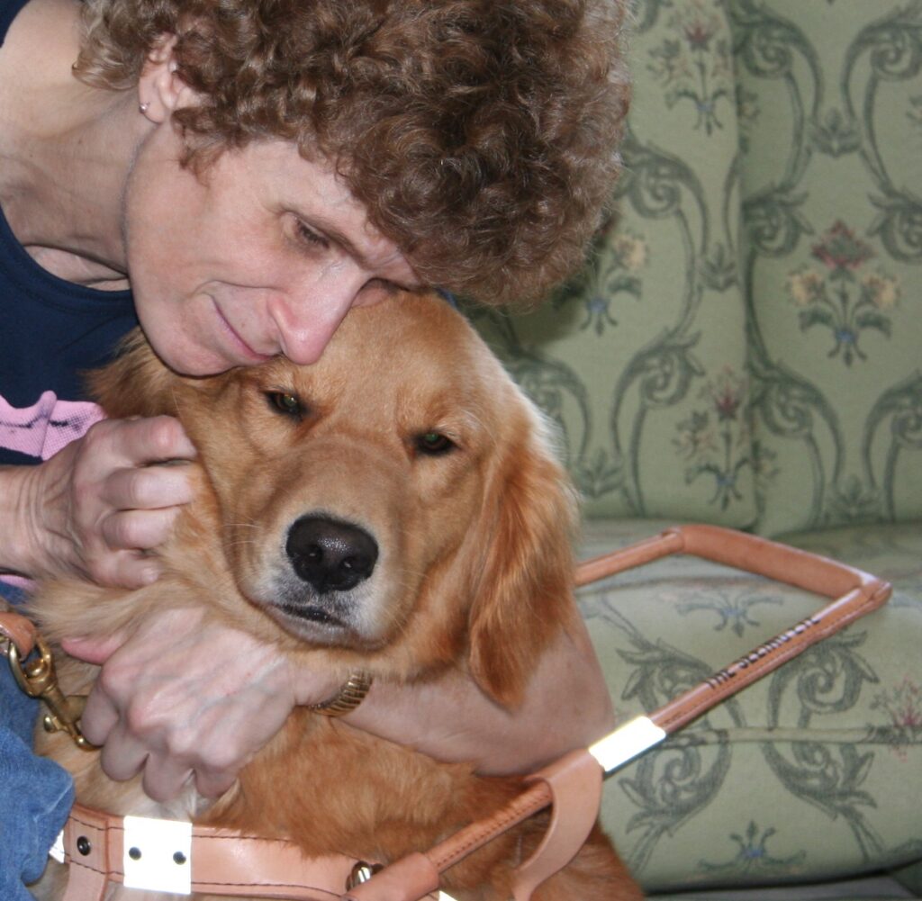 A Seeing Eye graduate hugs her Seeing Eye dog, a golden retriever.