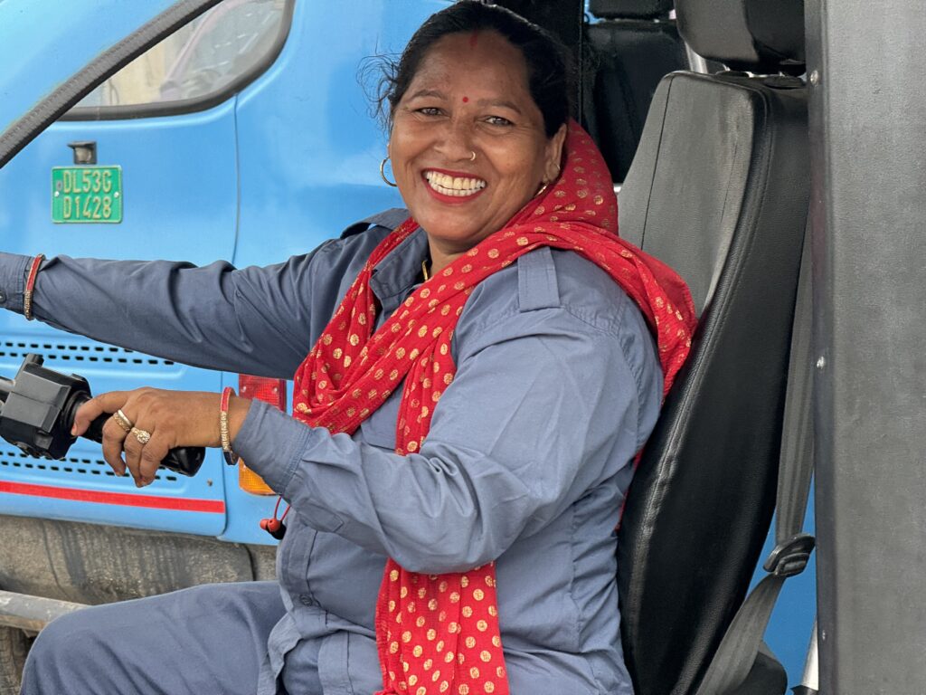 Woman electric rickshaw driver smiling