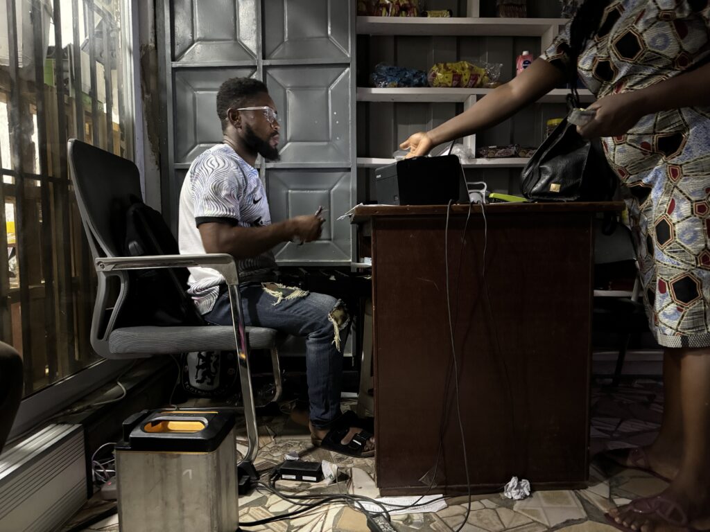 Man using a battery to power cash register