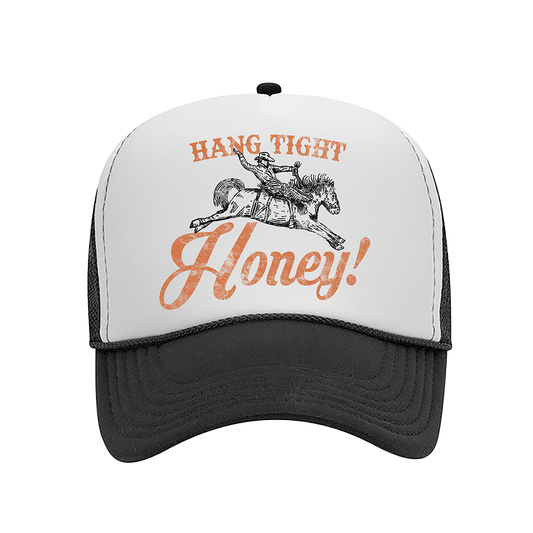 Trucker-style cap with ’Hang Tight Honey!’ text and a cowboy on horseback graphic.