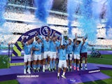 Manchester City's Ilkay Gundogan lifts the trophy as he celebrates with teammates after winning the Premier League on May 21, 2023