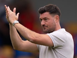 AFC Wimbledon head coach Johnnie Jackson applauds fans after the match on July 27, 2024