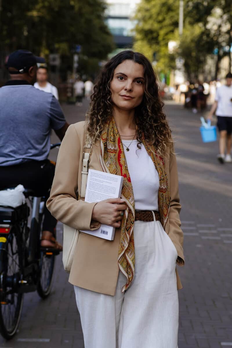 A scholarly woman on a bustling street.