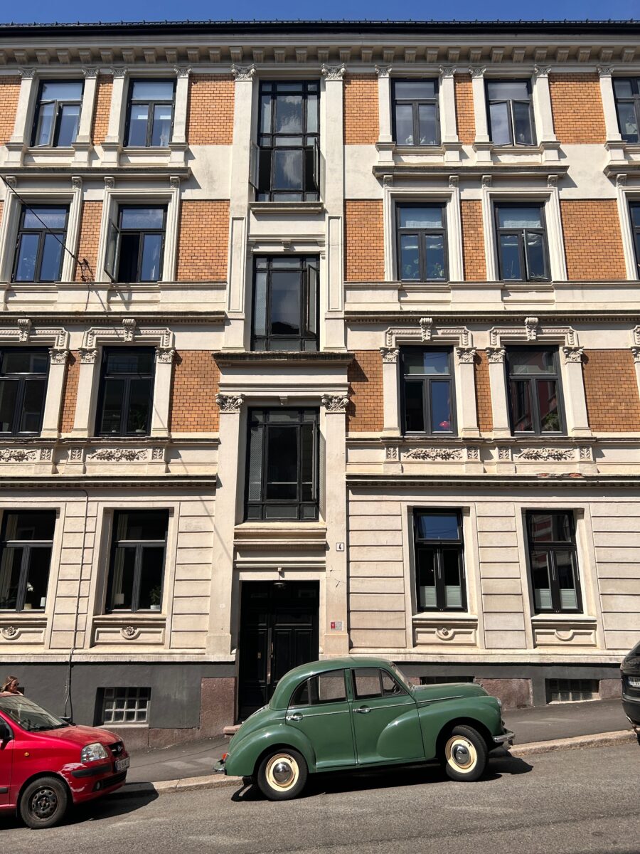 a picturesque street in Oslo with a vintage car and colourful facades