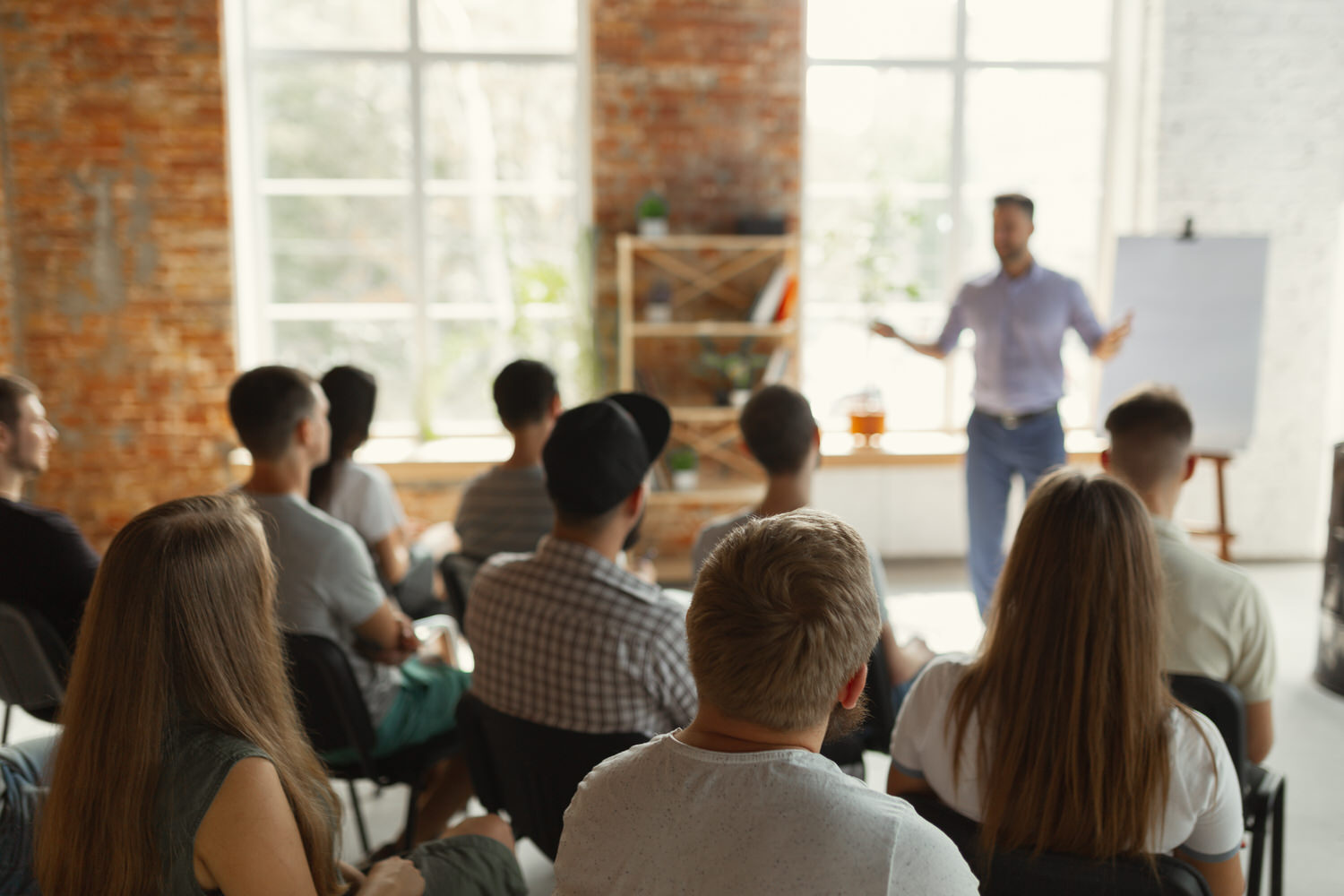 male speaker giving presentation in university classroom