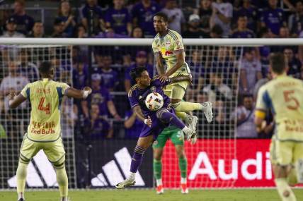 Mar 30, 2024; Orlando, Florida, USA; Orlando City midfielder Facundo Torres (10) and New York Red Bulls defender Kyle Duncan (6) battle for the ball during the first half at Inter&Co Stadium. Mandatory Credit: Russell Lansford-USA TODAY Sports