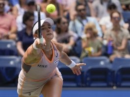 Caroline Dolehide, of the United States, returns a shot to Danielle Collins, of the United States, during the first round of the U.S. Open tennis championships, Tuesday, Aug. 27, 2024, in New York. (AP Photo/Seth Wenig)