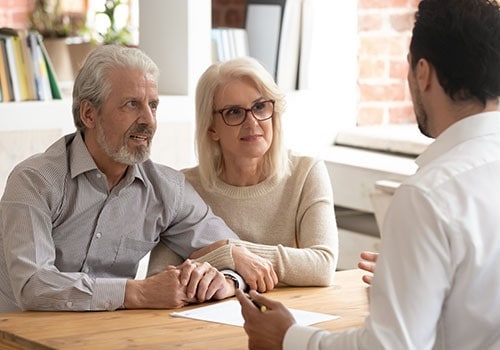 A couple discussing their disability (SSDI) appeal with their attorney.