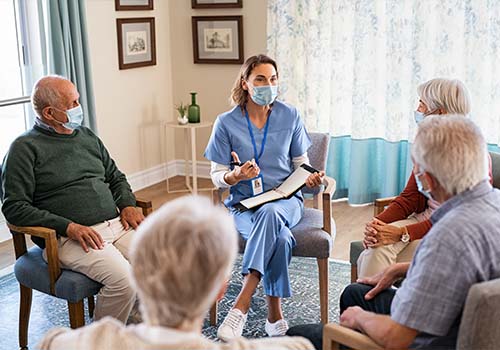 Group Of Elderly Seniors Listening To Nurse