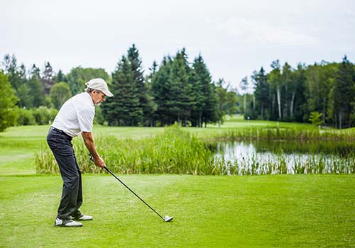 Retired Man Getting Ready To Swing Golf Club