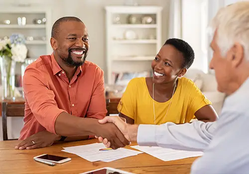 Mature Black Man Shaking Hands With Senior Insurance Agent