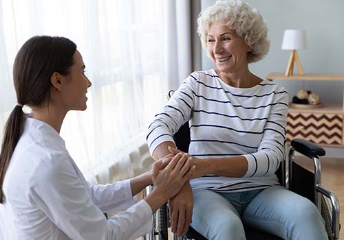 Female Nurse Supporting Elderly Woman