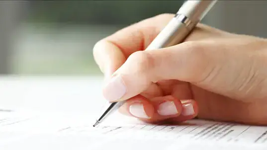 A woman filling in a social security change of address form.