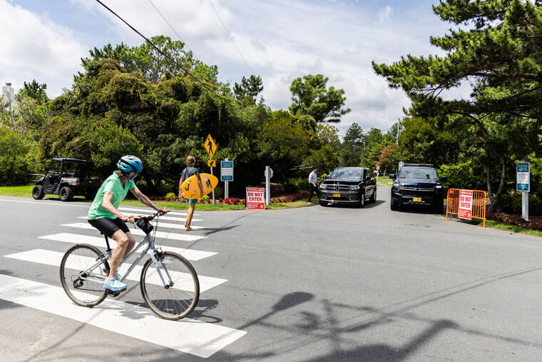 REUTERS/JEENAH MOON / JULY 23
                                A biker rides near the residence of President Joe Biden, after Biden announced he is stopping his bid for reelection, in Rehoboth Beach, Del.