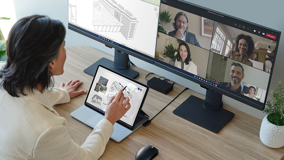 A woman engages in a video call with multiple attendees