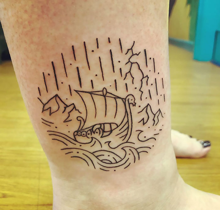 Viking ship tattoo with mountains and waves, showcasing minimalist black line art.