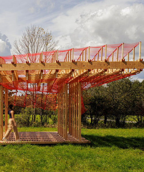 red mesh drapes over wooden curtain call pavilion by office office in woodstock's grounds