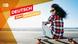 A young woman sitting on a skateboard near a beach. On the left side the slogan "Deutsch zum mitnehmen" is displayed.