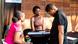 Three people in discussion, standing at a bar table