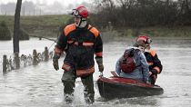 A resident of La Faute sur Mer, on the Atlantic coast in south western France is evacuated by firefighters as a result of a storm.