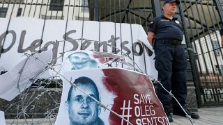 Barbed wire and placards with images of Ukrainian film director Oleg Sentsov are seen after a rally demanding the release of Sentsov