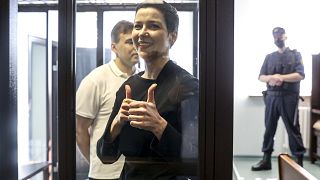 Belarus' opposition activists Maria Kolesnikova, foreground, and Maxim Znak, behind her, attend a court hearing in Minsk, Belarus, Wednesday, Aug. 4, 2021.