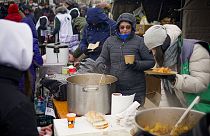 FILE PHOTO - Volunteers serve hot food to refugees fleeing the conflict from neighbouring Ukraine at the Romanian-Ukrainian border, in Siret, Romania, Wednesday, March 2, 2022