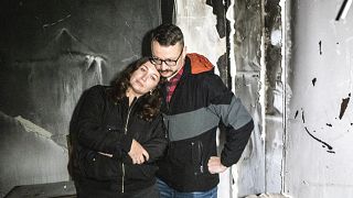 Anastasia and Roman Akulenko stand in their flat covered with ash. Irpin, Kyiv suburb, Ukraine. September 27, 2022