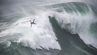 French surfer Eric Rebiere rides a wave during the Tudor Nazare Tow Surfing Challenge at Praia do Norte in Nazare, Portugal. February 10, 2022