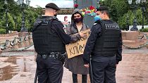 Russian police officers speak with climate activist Arshak Makichyan during a single-person demonstration in central Moscow, Russia in 2020.