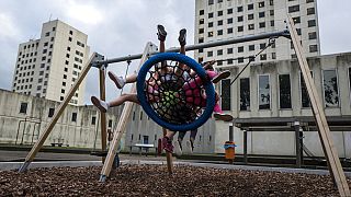 A group of Syrian refugee girls enjoy a swing ride in a yard at the former prison of Bijlmerbajes in Amsterdam, Netherlands, July 20, 2017.