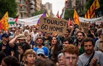 Demonstrators march shouting slogans against the Formula 1 Barcelona Fan Festival in downtown Barcelona, 19 June 2024.