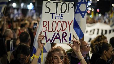 A demonstrator holds a sign during a protest marking nine months since the start of the war and calling for the release of hostages held in the Gaza.