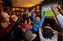 People celebrate in the Old Justice pub in London during the shootout of the quarterfinal match between England and Switzerland at the Euro 2024 tournament in Germany.