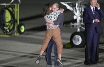 Reporter Evan Gershkovich hugs his mother, Ella Milman, as President Joe Biden, right, looks on at Andrews Air Force Base.