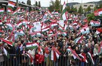 Participants wave national flags during a demonstration against public media at the MTVA headquarters in Budapest, October 5, 2024