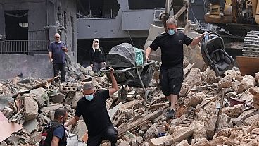 Residents of a building damaged in an Israeli airstrike in Beirut, Lebanon, on Saturday, 12 OCtober, 2024. 