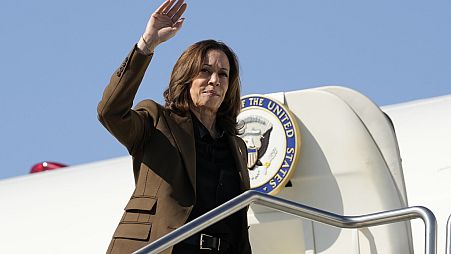 Democratic presidential nominee Vice President Kamala Harris waves  as she boards Air Force Two, Friday, Oct. 11, 2024,