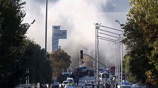 Smoke raises as emergency rescue teams and police officers attend outside Turkish Aerospace Industries Inc. on the outskirts of Ankara, 23 October 2024