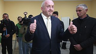 Former Georgian President Giorgi Margvelashvili gestures after voting at a polling station during the parliamentary election in Tbilisi, Georgia, Saturday, Oct. 26, 2024