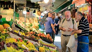 A man shops in a market in Istanbul, Monday, Aug. 13, 2018.