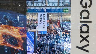 Visitors walk through the Mobile World Congress 2024 in Barcelona, Spain, Monday, Feb. 26, 2024